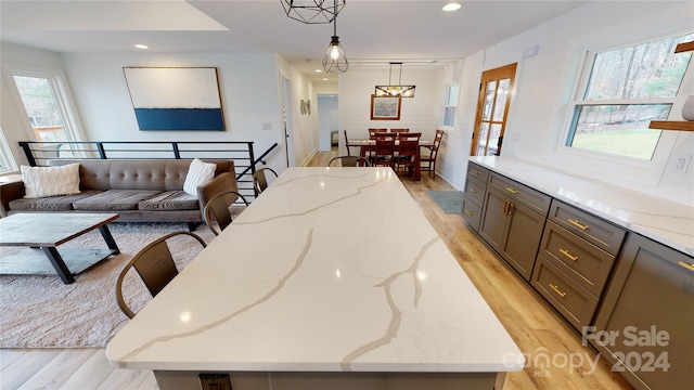 interior space featuring an inviting chandelier and light hardwood / wood-style flooring