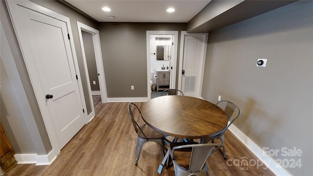 dining room with hardwood / wood-style floors and sink