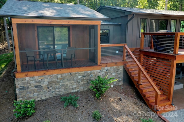 exterior space featuring a sunroom