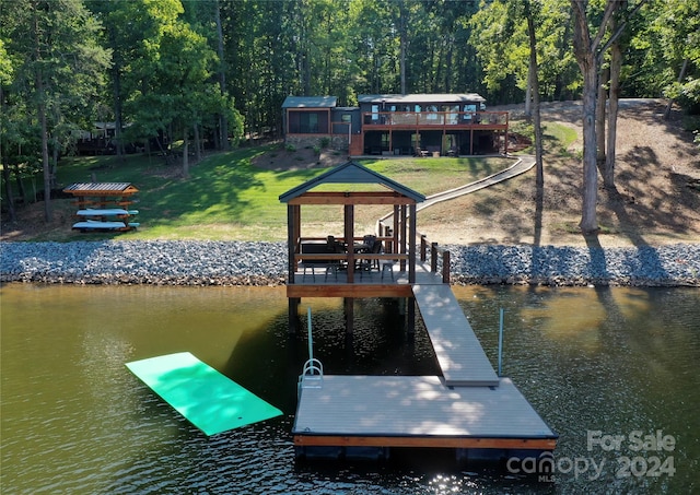 dock area featuring a water view and a yard