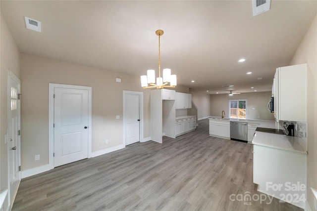 kitchen featuring kitchen peninsula, white cabinetry, light wood-type flooring, and appliances with stainless steel finishes