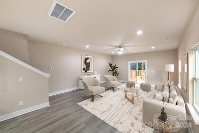 living room featuring ceiling fan and wood-type flooring