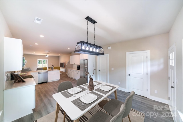 dining area with dark hardwood / wood-style flooring