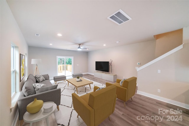 living room featuring ceiling fan and light hardwood / wood-style floors