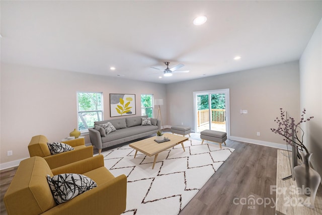 living room featuring ceiling fan and light hardwood / wood-style floors