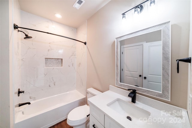 full bathroom with vanity, toilet, and tiled shower / bath