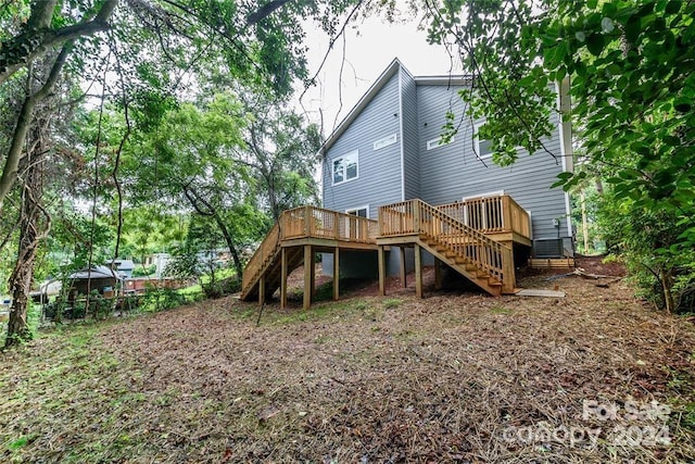 rear view of property with a wooden deck