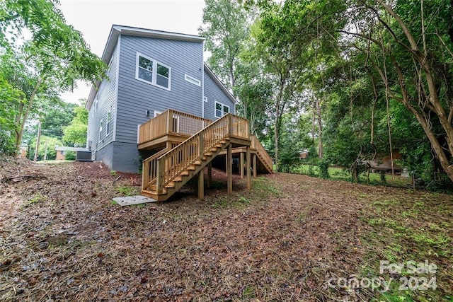 back of house with a deck and central AC unit