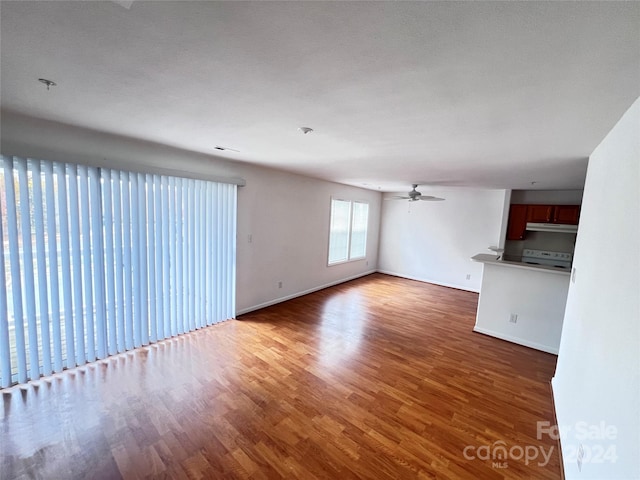 unfurnished living room with a textured ceiling and hardwood / wood-style flooring