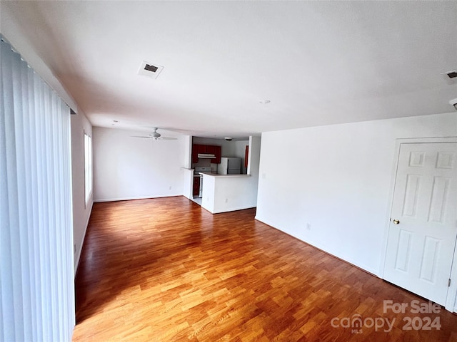 unfurnished living room with wood-type flooring