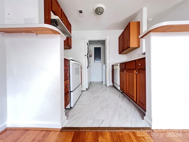 kitchen featuring light wood-type flooring and white appliances