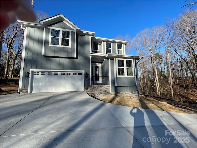 view of front facade featuring a garage, board and batten siding, and concrete driveway