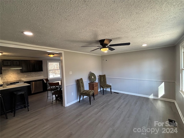 sitting room featuring hardwood / wood-style flooring, crown molding, and a textured ceiling