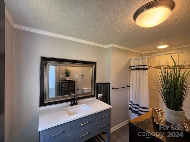 bathroom featuring wood-type flooring, a textured ceiling, and ornamental molding