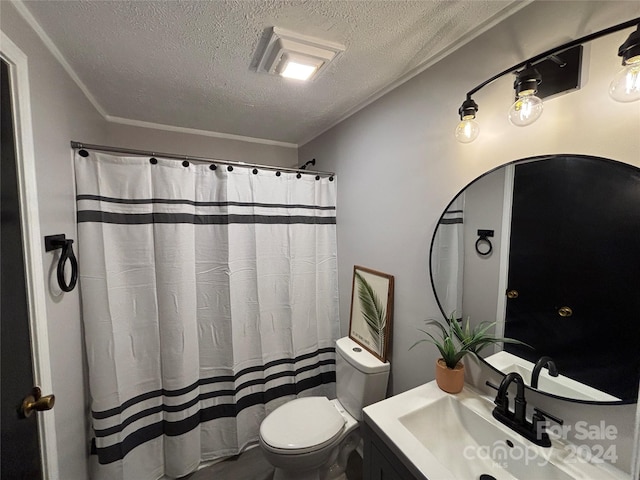 bathroom with vanity, toilet, a textured ceiling, and crown molding