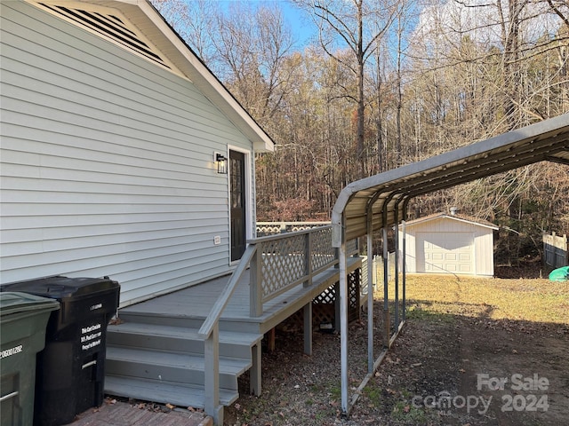 wooden terrace featuring a carport and a storage shed