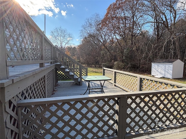 wooden terrace with a shed