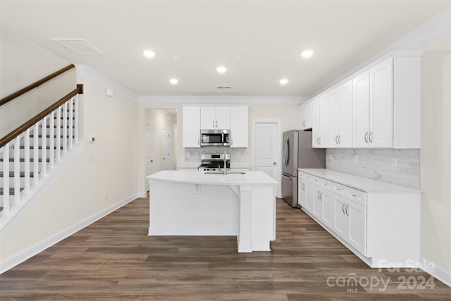 kitchen with backsplash, a kitchen island with sink, appliances with stainless steel finishes, dark hardwood / wood-style flooring, and white cabinetry