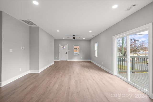 unfurnished living room with ceiling fan and light hardwood / wood-style floors