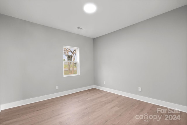 spare room with wood-type flooring