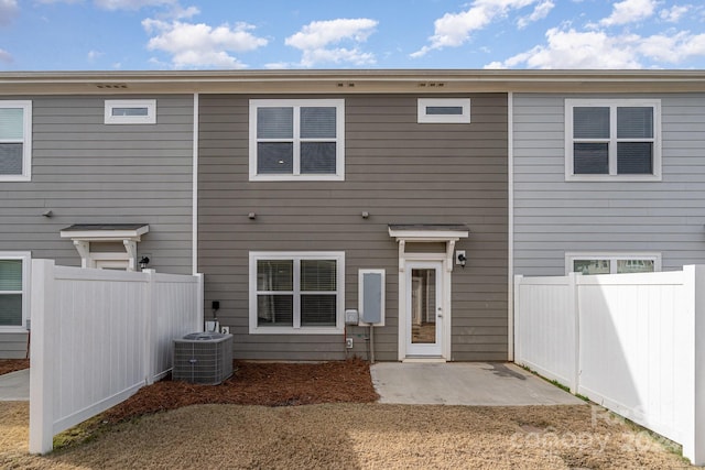 rear view of house featuring central AC unit and a patio