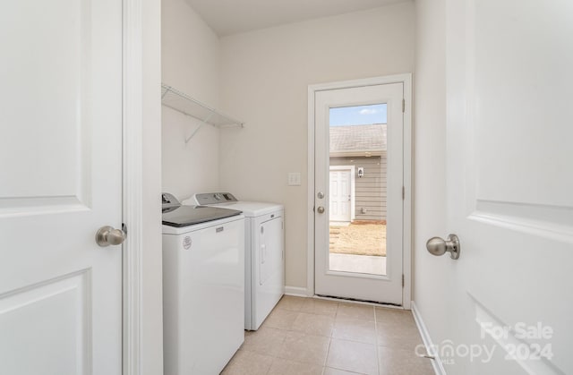 clothes washing area featuring washing machine and clothes dryer and light tile patterned flooring