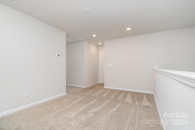 unfurnished room with light carpet