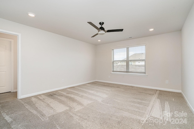 empty room featuring carpet and ceiling fan