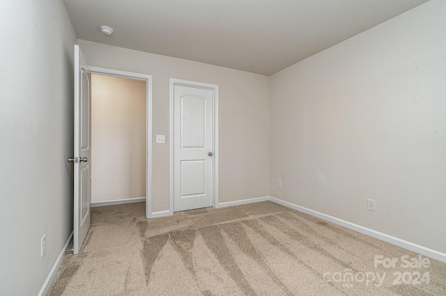 empty room featuring light carpet