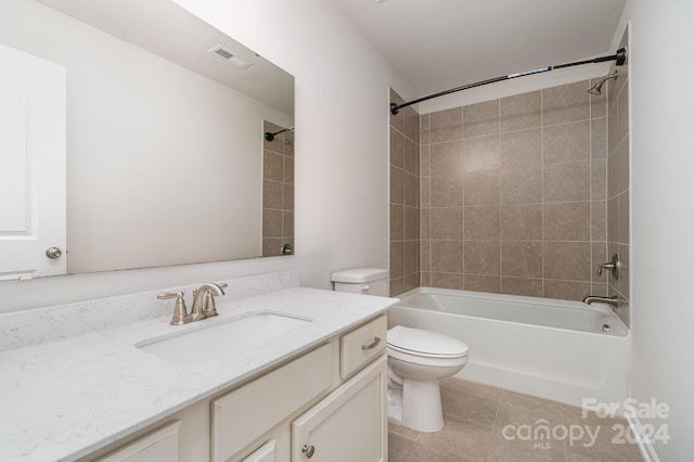 full bathroom with tile patterned flooring, vanity, toilet, and tiled shower / bath