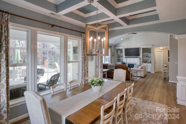 dining area with beam ceiling, hardwood / wood-style flooring, crown molding, and coffered ceiling