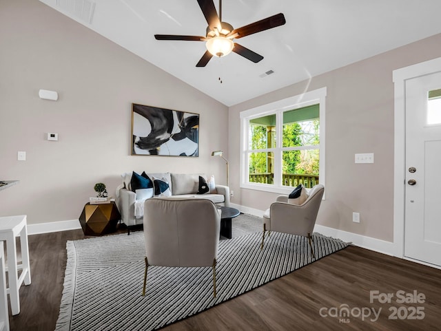 living room featuring ceiling fan, vaulted ceiling, and dark wood-type flooring