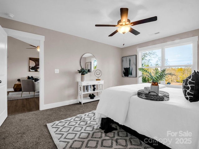 bedroom featuring ceiling fan and dark colored carpet