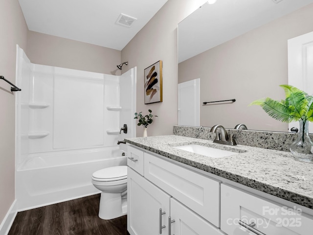 full bathroom featuring shower / tub combination, hardwood / wood-style floors, vanity, and toilet