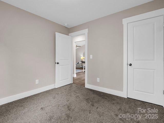 unfurnished bedroom featuring dark carpet