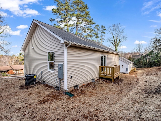 view of side of home with central AC unit