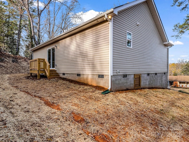 view of side of home with a wooden deck