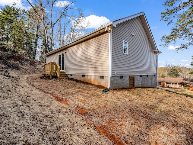 view of home's exterior featuring a wooden deck