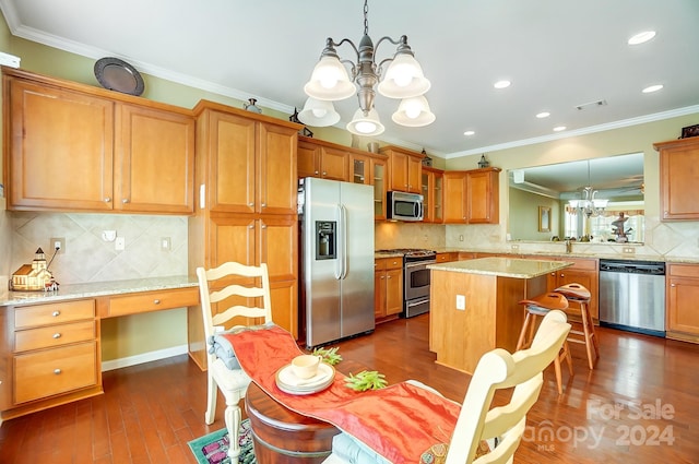 kitchen with a center island, crown molding, dark hardwood / wood-style floors, decorative light fixtures, and stainless steel appliances