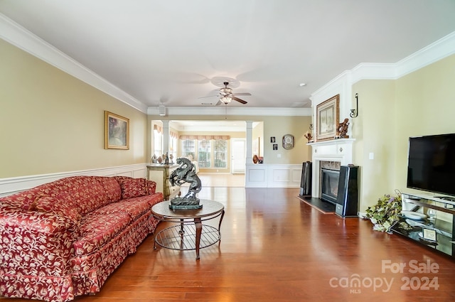 living room featuring ornate columns, ceiling fan, hardwood / wood-style floors, and ornamental molding