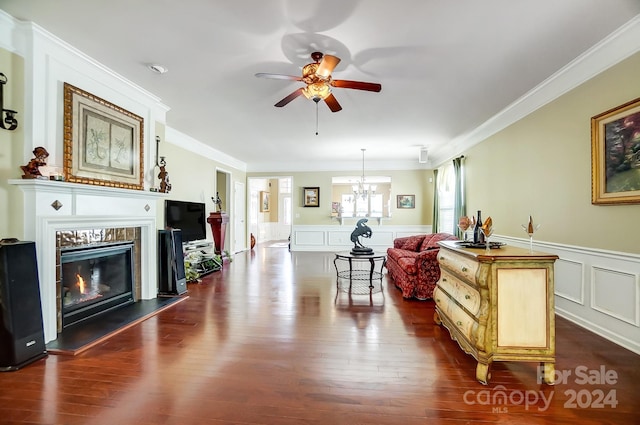 living room featuring ceiling fan with notable chandelier, dark hardwood / wood-style floors, and crown molding