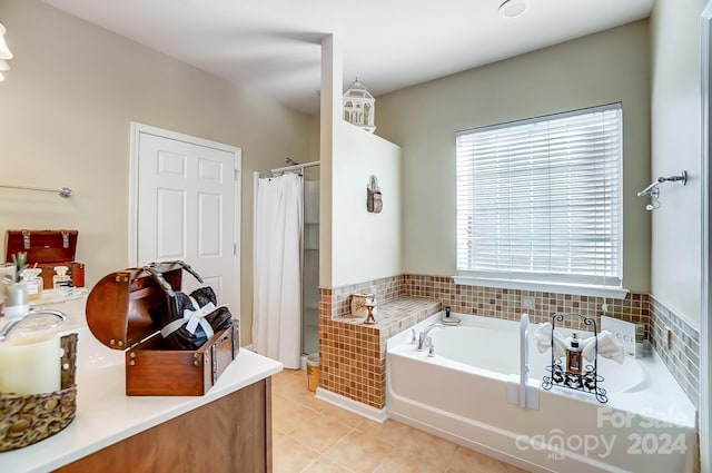 bathroom with separate shower and tub and tile patterned flooring