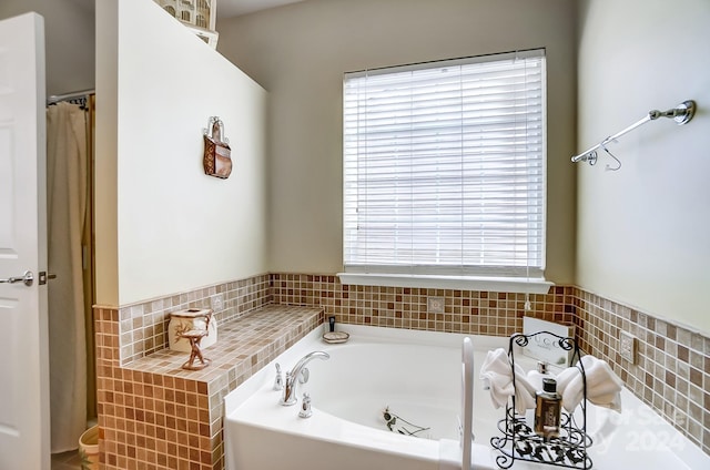 bathroom featuring tiled tub