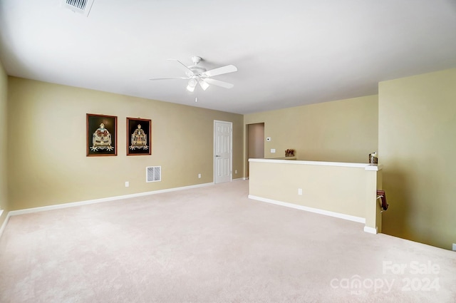 unfurnished room featuring light carpet and ceiling fan