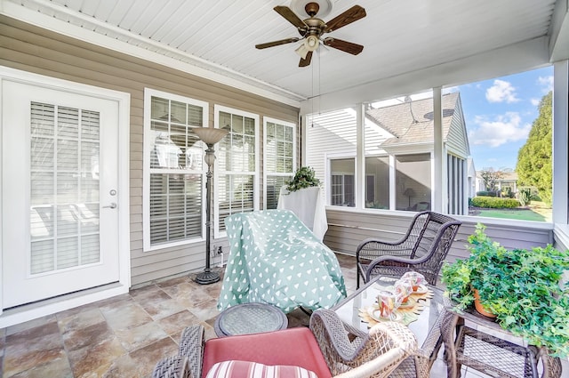 sunroom / solarium with a wealth of natural light and ceiling fan