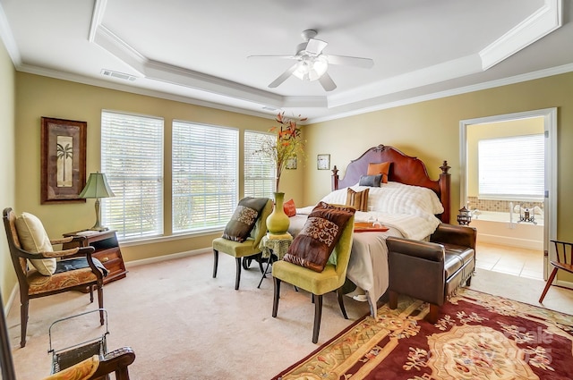 bedroom with a raised ceiling, crown molding, visible vents, and light carpet