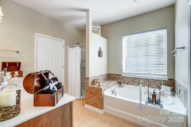 bathroom featuring tile patterned floors, a garden tub, and a shower with curtain