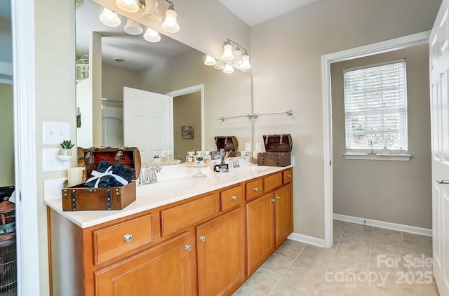 full bathroom with tile patterned flooring, double vanity, baseboards, and a sink