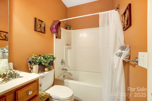 bathroom featuring vanity, shower / tub combo, and toilet