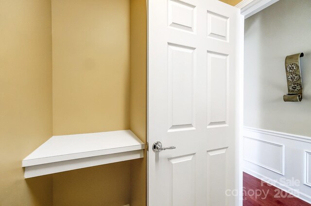 interior space featuring wainscoting and a decorative wall